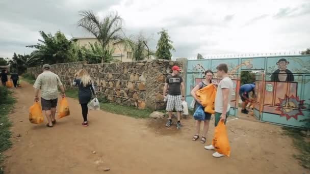 Kisumu, kenia - 15. Mai 2018: Gruppe kaukasischer Menschen mit Paketen. die Freiwilligen reisten nach afrika, um den armen familien zu helfen. — Stockvideo