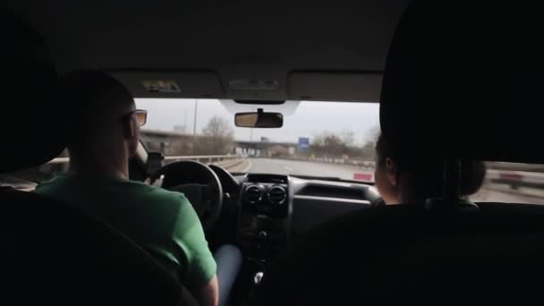 Mąż i żona podróżujesz samochodem na autostradzie. Widok z tyłu — Wideo stockowe