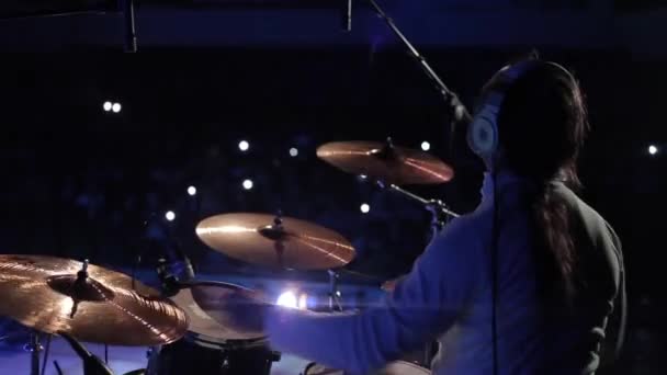 Bobruisk,Belarus - JULY 31, 2018: Rear view of a guy playing the drum set on a concert. Audience with camera flashes on — Stock Video