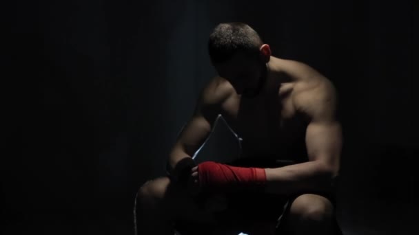 Un joven deportista fuerte decepcionado sentado y mirando hacia abajo. Un boxeador molesto después del fracaso — Vídeos de Stock