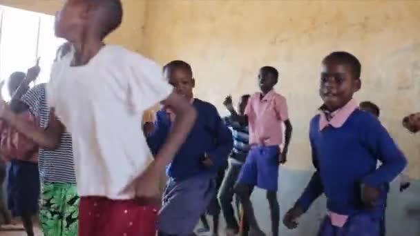 KENYA, KISUMU - MAY 20, 2017: African children in uniform dancing together in local school after lessons. — Stock Video
