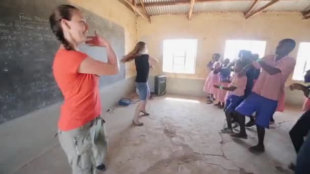 케냐, 키 수 무-5 월 20 일, 2017: 행복 백인 여자 작은 지역 학교에서 아프리카 아이 들과 함께 춤을. — 비디오