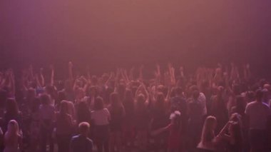 Misk, Belarus - 15 Mayıs 2017: Konser önünde parlak sahne ışıkları kalabalık. Koyu arka plan, duman, konser projektör. İnsanlar bir konserde dans ediyor.