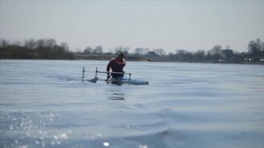Nehirde bir kanoyla özürlü adam kürek çekiyor. Kürek, Kano, kürek çekme. Eğitim. Kayak. paraolympic spor