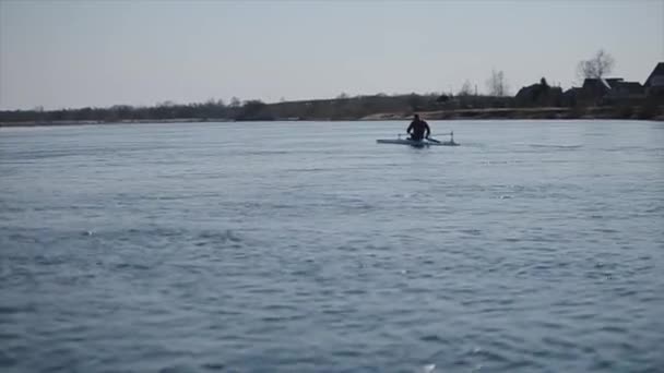 Wide view of Disabled sportsman rowing on the river in a canoe. Rowing, canoeing, paddling. Training. Kayaking. paraolympic sport. canoe for disabled people. — Stock Video