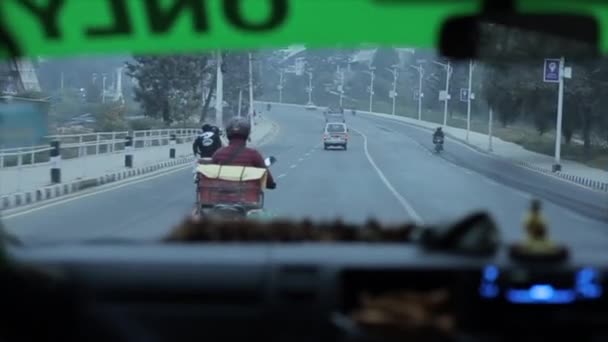 Delhi, India - 29 November 2019: Pemandangan melalui kaca depan mobil di jalan yang sibuk di kota Kathmandu, Nepal pada malam hari. Semua mobil dengan lampu menyala. Close-up — Stok Video