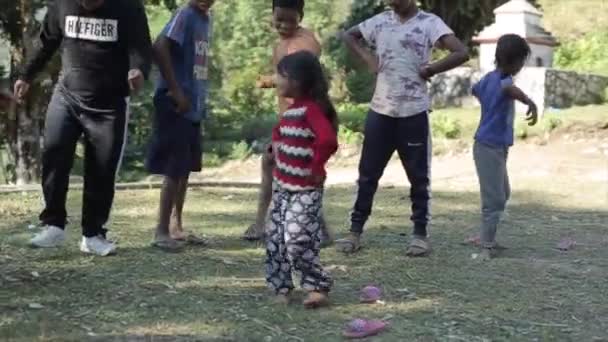 Pokhara, Nepal - 18 November 2019: A beautiful nepalese girl dancing with other kids. Smiling, nature. — Stock Video