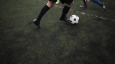 Antrenmandaki futbol takımının oyuncuları şehir stadyumunda top taşıma tekniği uyguladılar. Yakın plan.