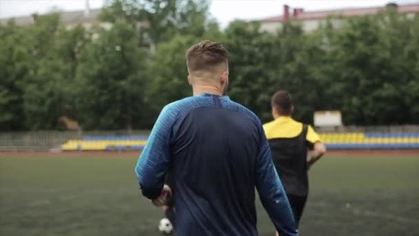 Slow motion training process soccer club. Back view. The camera changes focus. Close-up — Stock Video