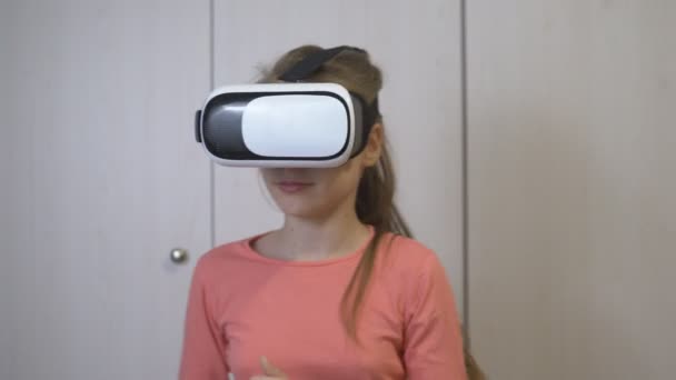 彼女の仮想現実のヘッドセットと喜んで仮想世界に十代の少女が着ています — ストック動画