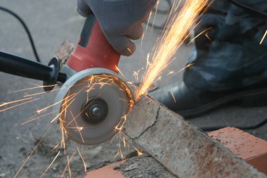  adam sıradan giysiler ve atölye kesme metal çalışırken açı değirmenleri ile koruyucu gözlük