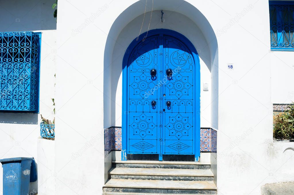 Decorative blue entrance door to the white house Sidi Bou Said, Tunisia.