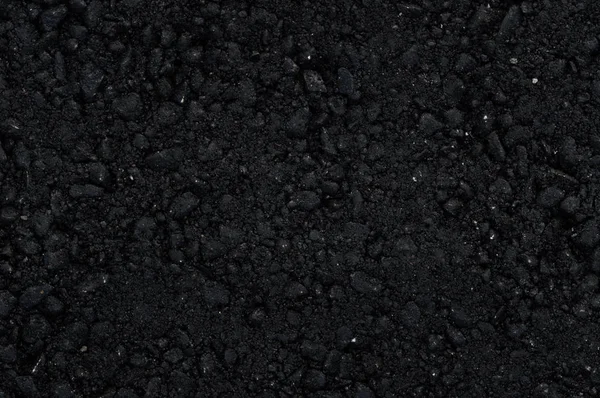Ny svart asfalt yta med stora bråk. — Stockfoto