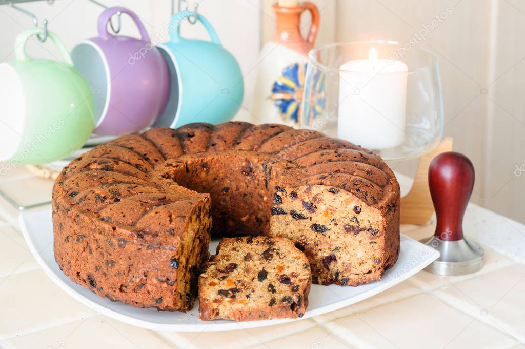 Cake with dried fruits and nuts, cups for tea, temper.