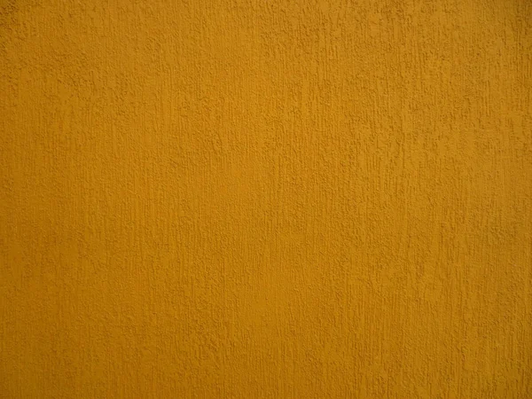 有纹理的墙壁丰富的深黄色. — 图库照片