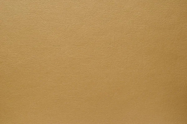 The texture of the surface of artificial brown skin warm shade. — Stock Photo, Image