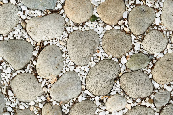 Large stones and fine white gravel for paving.
