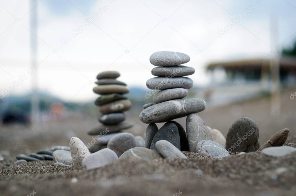 The pyramid of pebbles on the beach, selective focus.
