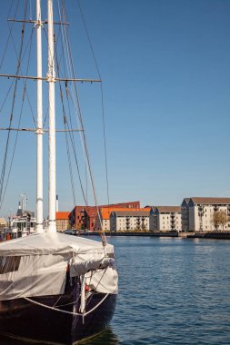 COPENHAGEN, DENMARK - MAY 6, 2018: yacht moored in harbour and beautiful cityscape in copenhagen, denmark clipart
