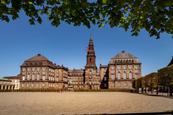 Urban scene with historical Christiansborg Palace and blue sky in Copenhagen, denmark