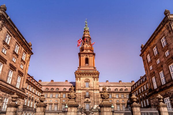 Urban scene with historical Christiansborg Palace against clear blue sky, Copenhagen, denmark