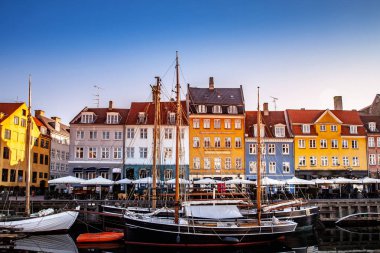 COPENHAGEN, DENMARK - MAY 6, 2018: scenic view of beautiful colorful buildings and boats moored in harbor, copenhagen, denmark clipart