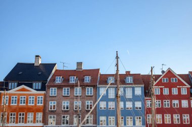 beautiful colorful historical buildings against blue sky in copenhagen, denmark clipart