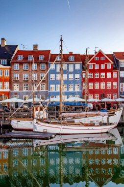 COPENHAGEN, DENMARK - MAY 6, 2018: boats and beautiful historical buildings reflected in calm water, copenhagen, denmark clipart