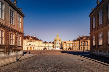 beautiful cityscape with historical buildings and old cathedral on empty square in copenhagen, denmark clipart