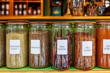close up image of different spices in jars placed in row clipart
