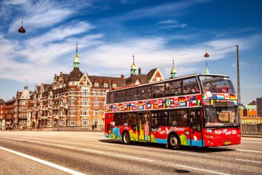 COPENHAGEN, DENMARK - MAY 6, 2018: Sightseeing bus with tourists on street in Copenhagen, Denmark clipart