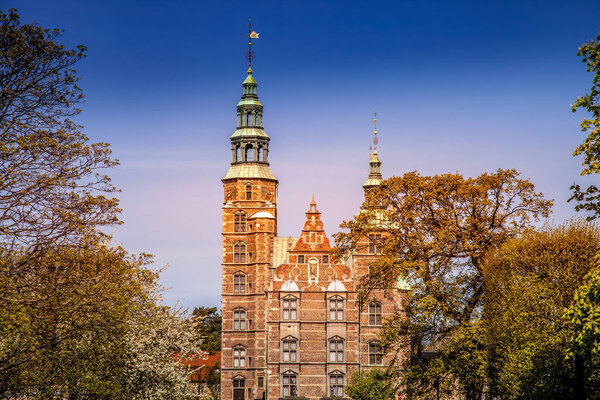 scenic view of beautiful historical palace between trees in copenhagen, denmark