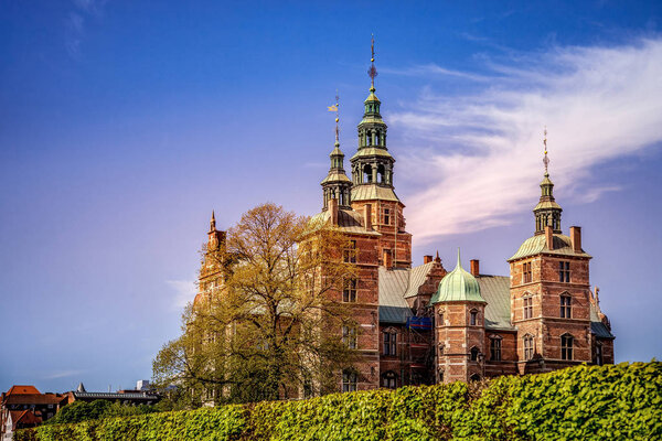beautiful palace on green hill against blue sky, copenhagen, denmark