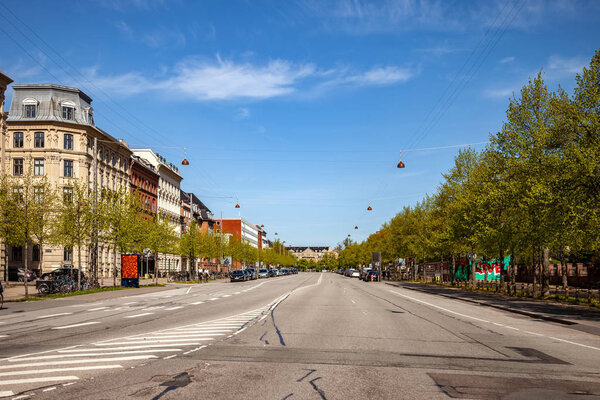 COPENHAGEN, DENMARK - MAY 6, 2018: cityscape and road with parked cars 