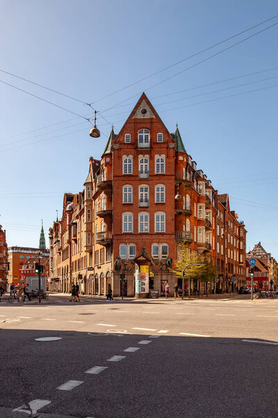 COPENHAGEN, DENMARK - MAY 6, 2018: cityscape with buildings and people walking on street in Copenhagen, Denmark