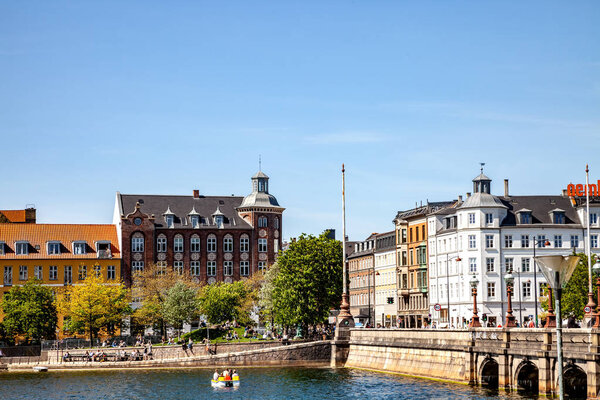COPENHAGEN, DENMARK - MAY 6, 2018: scenic view of cityscape with river and bridge under clear blue sky 