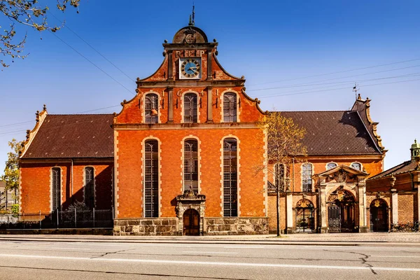 Old building with clock on empty street at sunny day, copenhagen, denmark — Stock Photo