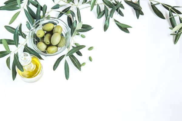 olive oil and olives on the white background