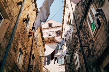 urban scene with laundry and empty narrow city street in Dubrovnik, Croatia clipart