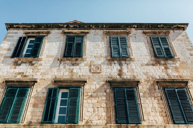 low angle view of historical building and clear blue sky in Dubrovnik, Croatia clipart
