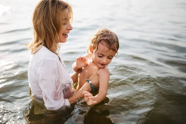 Happy Mom Holding Daughter River Stock Picture