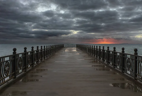 A sea pier under the thunder sky