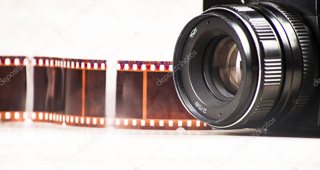 Concept of analog photography, camera on a background of colored negatives