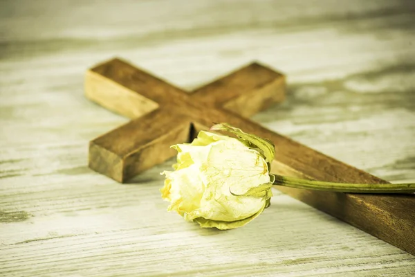 Eine Verwelkte Rose Vor Dem Hintergrund Eines Kreuzes Auf Hellen — Stockfoto