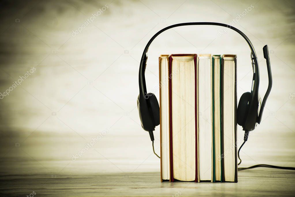 Concept of audiobooks, headphones with a microphone and books
