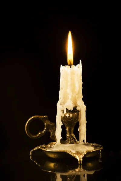 Зажгла свечу в подсвечнике на черном фоне — стоковое фото