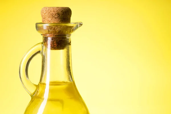 A bottle of oil on a yellow background — Stock Photo, Image