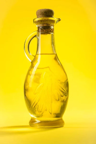 A bottle of oil on a yellow background — Stock Photo, Image