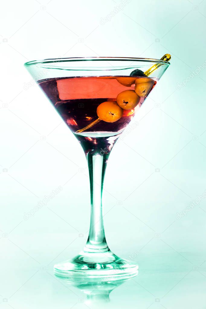 Martini glass with green olives