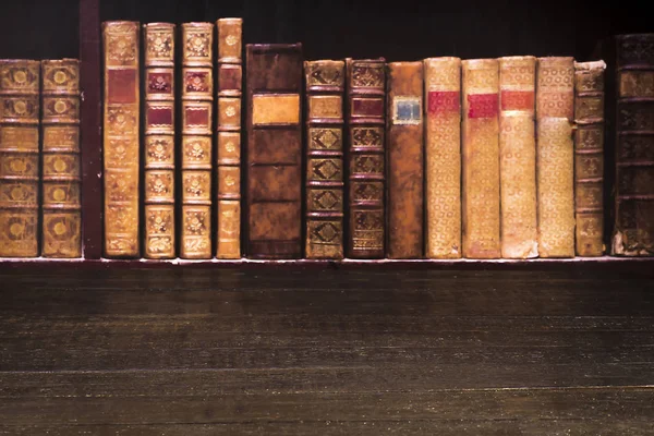 Table top from old boards on the background of shelves with old — Stock Photo, Image